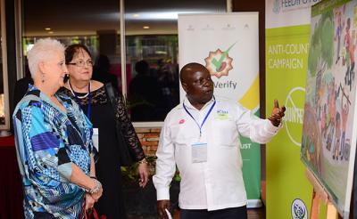 Beneficiary from the Anti-Counterfeit Campaign highlighting their impact in Uganda over the past 5 years to U.S. Ambassador to Uganda, Deborah R. Malac