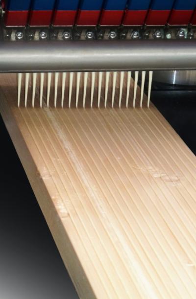 Cross-laminated timber beams are constructed using solid-sawn lumber and adhering layers with adhesive. This improves the structural integrity and rigidity of the beam or panel.