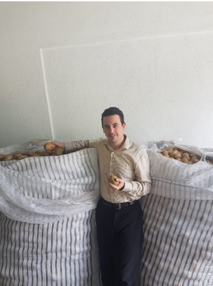 Julien Bulliard, Executive Director of Banco de Alimentos Republica Dominicana, stands by bags of potatoes in the food bank’s newly expanded warehouse. PepsiCo’s grant to GFN allowed the food bank to make critical infrastructure improvements, including tripling the size of its storage space and adding a 20-foot refrigerator.