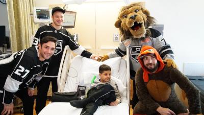 LA Kings players (from left to right) Alec Martinez, Dustin Brown, Drew Doughty and team mascot Bailey visit with patients at Children’s Hospital Los Angeles during the club’s annual team (Halloween-themed) visit on October 29, 2019.