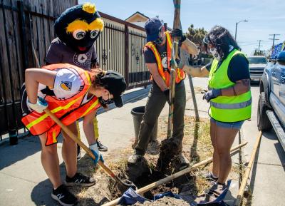 AEG and LA Galaxy staff team up with TreePeople to plant trees in a Watts neighborhood in Los Angeles, with the help of LA Galaxy mascot, Cozmo, in celebration of Earth Month on April 29, 2021.