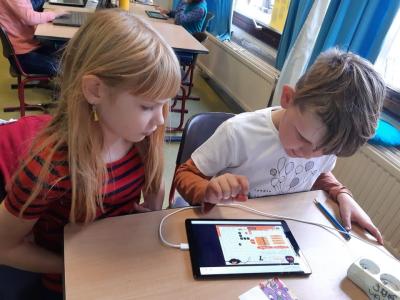 Students practice lessons through a tablet game. Photo Courtesy of DeBroeBELschool.