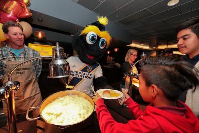 LA Galaxy mascot Cozmo assists AEG employees in serving more than 200 meals to children and families during the 16th Annual Thanksgiving Foundations’ Feast at Dignity Health Sports Park’s American Express Club on Friday, Nov. 22, 2019.