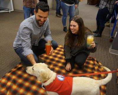 Employees pet a Hero Pups puppy at Timberland’s recent Fall Fest which offered an in-house celebration of the season and connected employees with new organizations and ways to serve the community.