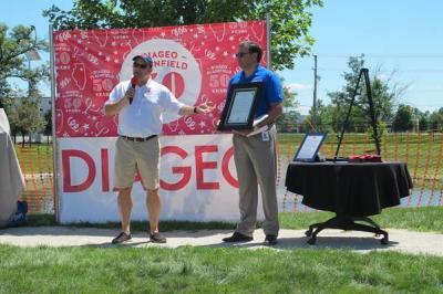 Illinois State Representative Mark Batinick (left) attended Diageo Plainfield’s 50th anniversary celebration. During a ceremony, he presented an Illinois Assembly Resolution honoring Diageo Plainfield for 50 years of commitment to the community to Pietro Di Pilato, Diageo’s Senior Vice President, Technical. (Photo: Diageo.)