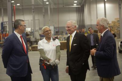 Danica Armstrong, Trane Columbia production leader, discusses operations at the recently expanded facility, with Donny Simmons, president, Trane Commercial HVAC North America and EMEA (far left), Governor Henry McMaster (middle), and Trane Columbia Plant Manager Gregg Krick (far right).