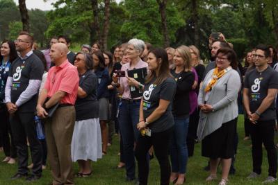 Kaylee Pohlmeyer (center, wearing General Mills Pride shirt), brand experience manager for Cheerios and president of Betty’s Family, watches the Pride flag ceremony.