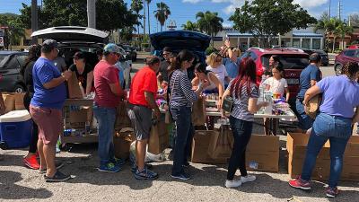 Walgreens team members and their families gather to pack supplies for communities in need.