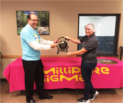 Jeffrey Lasselle, head of North American Distribution for MilliporeSigma, accepts the 500,000 meal milestone award from Tracey Edwards of Rise Against Hunger.