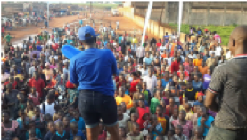 A representative introduces SATO at a market in Uganda