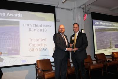 Fifth Third’s Director of Environmental Sustainability Scott Hassell accepts a Top 10 Corporate Solar Purchaser Award from Mike Smith, chief business officer of the Solar Energy Industries Association.
