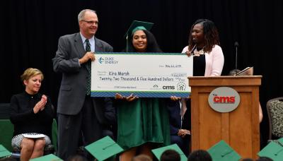 Kira Marsh receives her scholarship check from Principal Will Leach and Dominique Johnson of the Duke Energy Foundation.