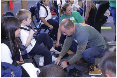 Timberland global brand president, Jim Pisani, volunteers at the brand’s annual Serv-a-palooza shoe fit event in Lawrence, MA. Timberland volunteers provided shoes to over 500 students while other volunteers served at additional project sites for the brand’s 22nd annual global day of service.