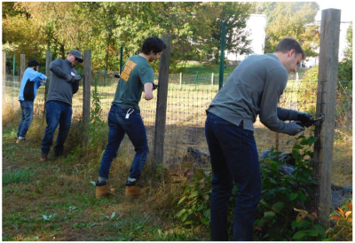 Timberland volunteers install a fence to protect crops at an urban farm in Lawrence MA as part of the brand’s 22nd annual Serv-a-palooza global day of service.