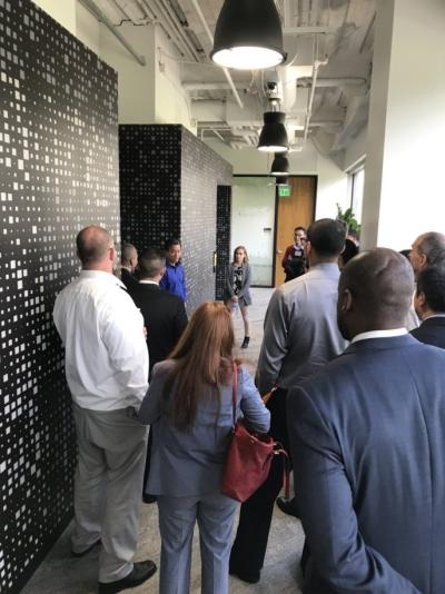 Symantec volunteer Tan Nguyen leads a group of NPower students through the data lab