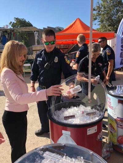 Nestle Waters NA Executive Vice President and Chief Corporate Affairs Officer Tara Carraro hands out bottled water to first responders attending California's Day of Preparedness.