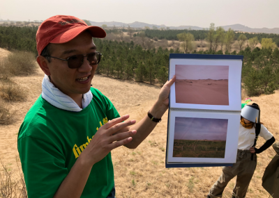 A representative of Green Network showed volunteers photos of the same piece of land in 2001 (top photo) 2009, lower photo. The land in the background is now covered with thousands of trees planted in partnership with Timberland since 2001.
