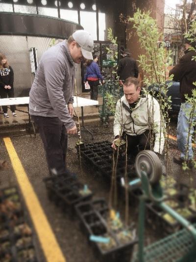 Boulder: Crowds lined up to collect various types of trees such as Pecan, Choke Cherry, Hickory and 2 varieties of Oak as TruGreen General Manager Caleb Hall and Sales Manager Michael Hudson.