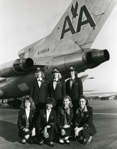 The first all-female crew ever to staff an American Airlines flight pose beside their Boeing 727 aircraft after arrival at Dallas/Fort Worth International Airport in December 1986. Standing, left to right: First Officer Tracy Prior, Capt. Beverley Bass and First Officer Terry Clairidge. Kneeling are Flight Attendants Sally Houston, Beverly Donawa, Nancy Hayth and Alice Chedister.