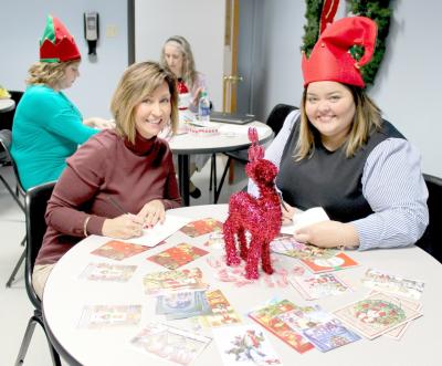 WHIRLPOOL Customer eXperience Center employees Patti Bowerman, left, and Shannon Russo prepare cards for the American Red Cross' "Holidays for Heroes" initiative.