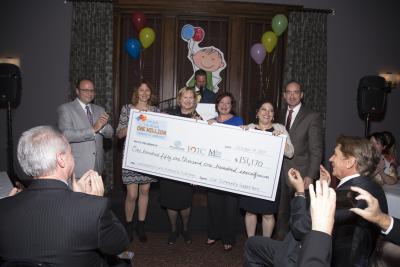 Representatives of Sanofi Pasteur, VaxServe, and the three non-profit recipients for the Lackawanna County Community Fundraiser pose behind a ceremonial check from the event. Since the inception of the local signature CSR program, more than $1,000,000 has been collectively raised to benefit families and children at risk living in Lackawanna County.
