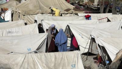 Stranded people crossing the border between Pakistan and Afghanistan, in Chaman, Pakistan, Aug. 13, 2021. | Jafar Khan/AP