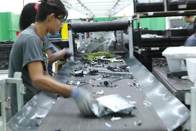 At the Sinctronics recycling facility, employees deconstruct equipment and sort parts with help from sensors that can distinguish between types of plastic that look identical to human eyes.