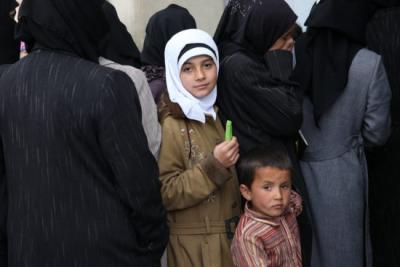 A girl waits in line in Al Bab, Syria. Mercy Corps delivered food baskets and winterization kits (jackets, blankets, mattresses and floor mats) to vulnerable and displaced people in Aleppo Governorate.