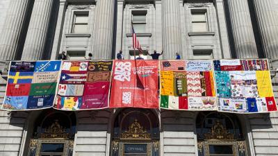 Several panels from The Quilt are being displayed on city hall buildings in San Francisco (pictured above) and Oakland during this week’s International AIDS Conference, which was originally planned to take place in the two cities and is now being held virtually. (Credit: National AIDS Memorial/Liz Highleyman)