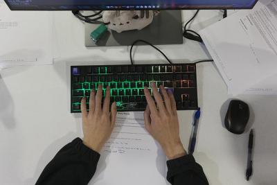 Student teams collaborate to solve coding challenges, reading problems aloud and working through solutions, with one member at the keyboard. Credit Alison Hess