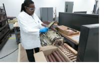 Using metal detecting wands, the General Motors Design team checks recovered clay for metal pins and processes the material in a pug mill recycling machine.