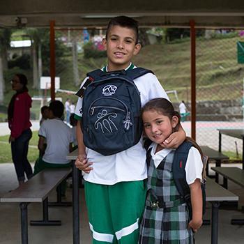 Siblings with their school kits at Miguel Valencia School