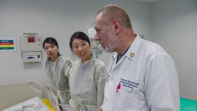 Shiori Hikichi (left) and Ayaka Sasaki with nursing trauma specialist Tim Murphy during a disaster preparedness simulation at the Rutgers School of Nursing