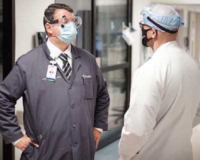 Chaplain Will Runyon (left) chats with a doctor between visiting patients at Phoebe Putney Memorial Hospital.