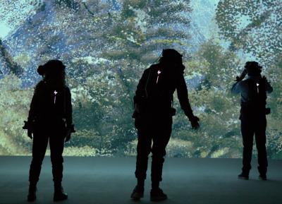 People walking through the "We Live in an Ocean of Air" VR installation at the Saatchi Gallery in London. photo by Mike Jones