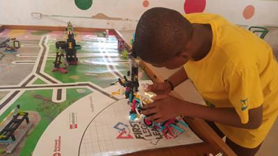 FIRST® Lego League student in Nigeria prepares his robot for competition