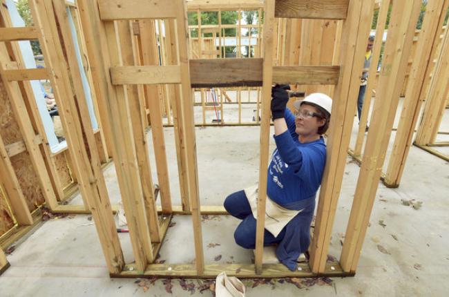 Carolyn Cline, with Whirlpool Corporation's legal department, works on a Habitat for Humanity build. Photo Credit: Don Campbell / HP Staff