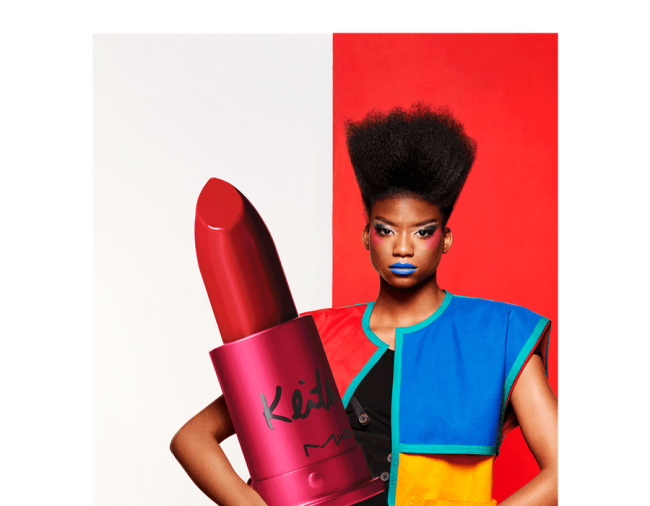 Person holding an oversized lipstick for display
