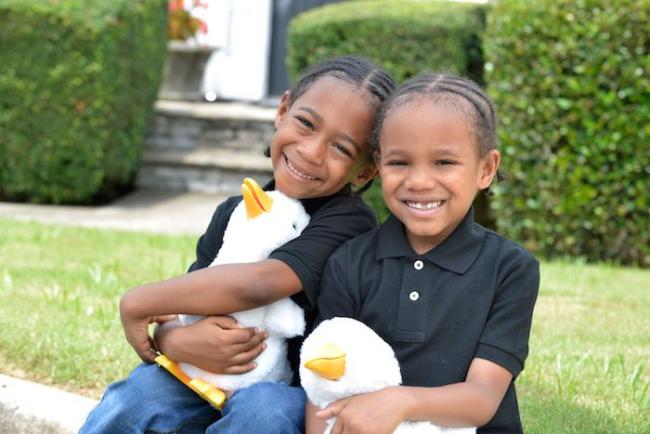 Two children holding My Special Aflac Duck, a social robot for children with cancer and sickle cell disease that was designed by the founders of Sproutel, a health tech company in Providence, R.I.SPROUTEL