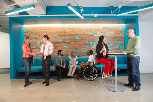 Booz Allen employees discussing topics in the McLean, VA office.