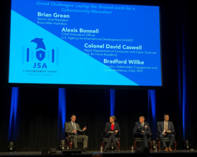 Pictured: Brian Green, Senior VP and cyber leader at Booz Allen Hamilton leads panel at the Joint Services Academy Cybersecurity Summit, featuring Alexis Bonnell, Chief Innovation Officer at the US Agency for International Development (USAID); Colonel David Caswell, Head, Department of Computer and Cyber Science, US Air Force Academy; and Bradford Willke, Director, Stakeholder Engagement and Cyber Resilience, Cybersecurity and Infrastructure Security Agency (CISA), Department of Homeland Security (DHS). Photo courtesy Sherri Ramsay