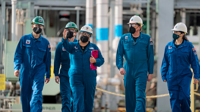 Chevron employees walk at processing plant