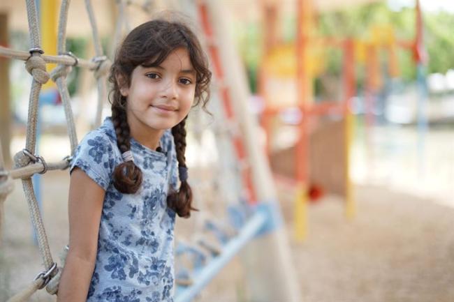 Young girl shown in a playground.