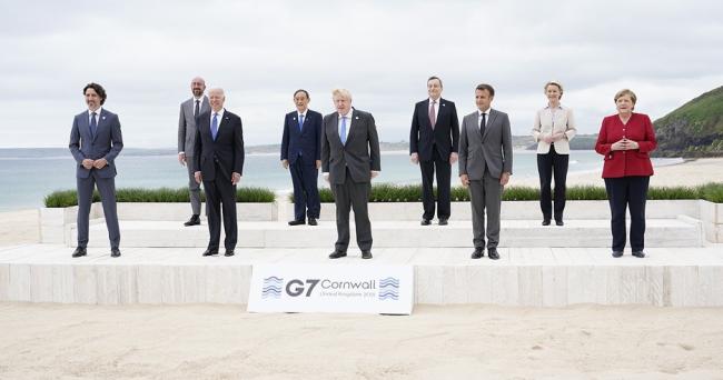 9 Leaders of the G7 pose for a group photo overlooking the beach