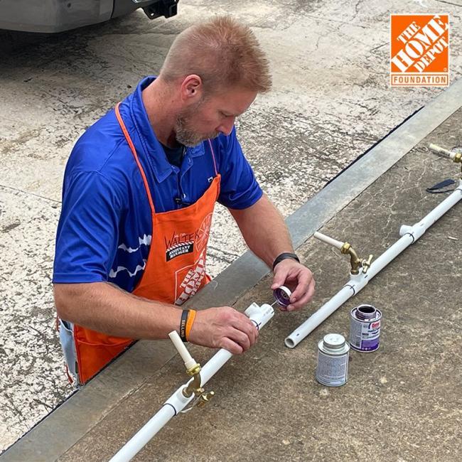 Home Depot volunteer installing the fresh water supply.