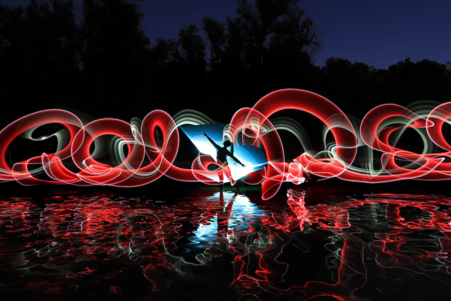 artistic image of red swirls and person in the dark