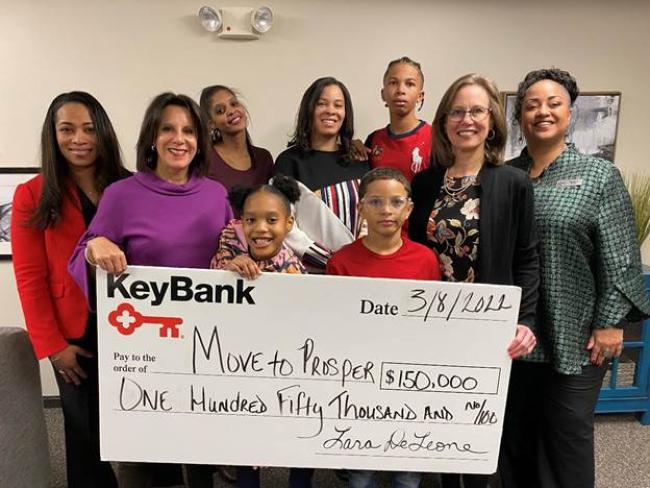 Photo caption: KeyBank Market President Lara DeLeone (second from left), along with Corporate Responsibility Officer Kenya Taylor (far right) and SVP, Service Digitization Tracie Cleveland Thomas (far left) present a grant to Move To Prosper President & CEO Amy Klaben (second from right) to support Empower 100 families (center).  