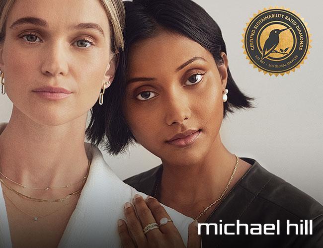 Two women wearing Michael Hill jewelry and SCS logo