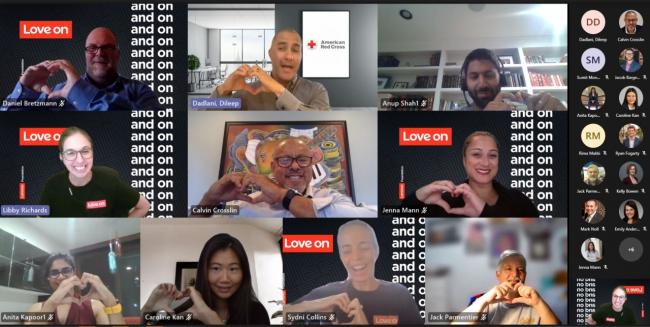 Lenovo employees make hearts with their fingers on a video call