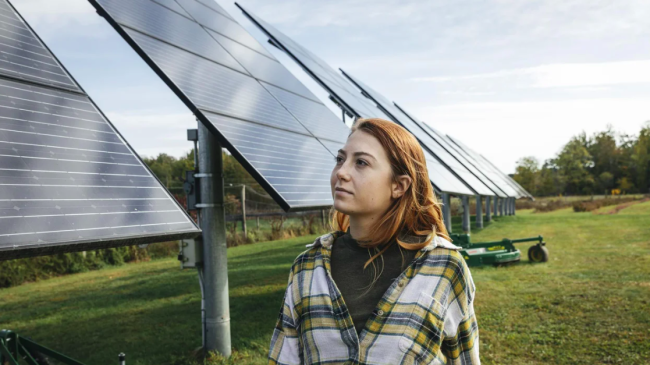 Woman standing in front of solar panels